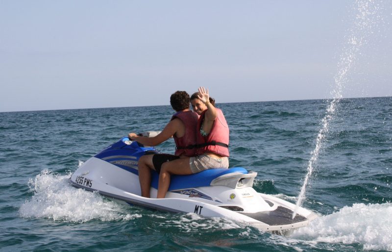 a girl riding a wave on a surfboard in the water