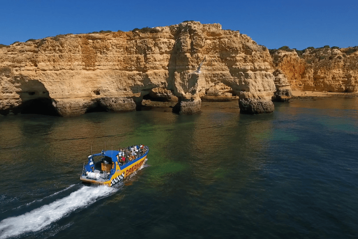 a small boat in a body of water with a mountain in the background