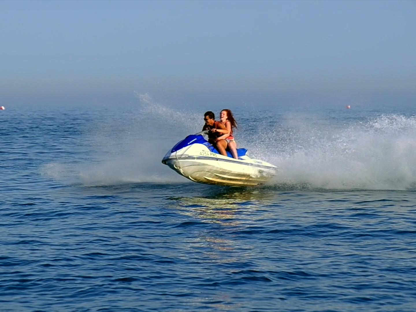 a man riding a wave on top of a body of water