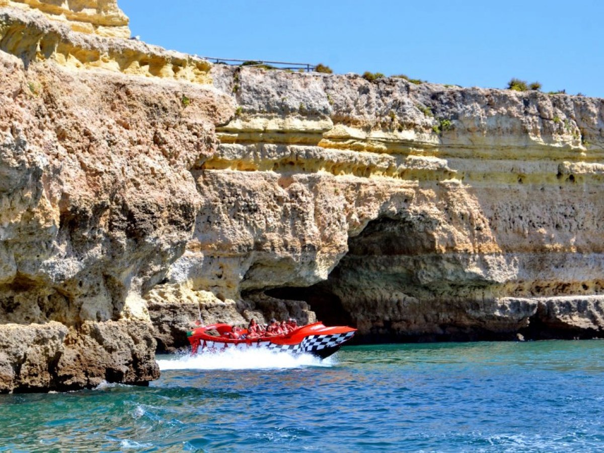 a person sitting on a rock near the ocean