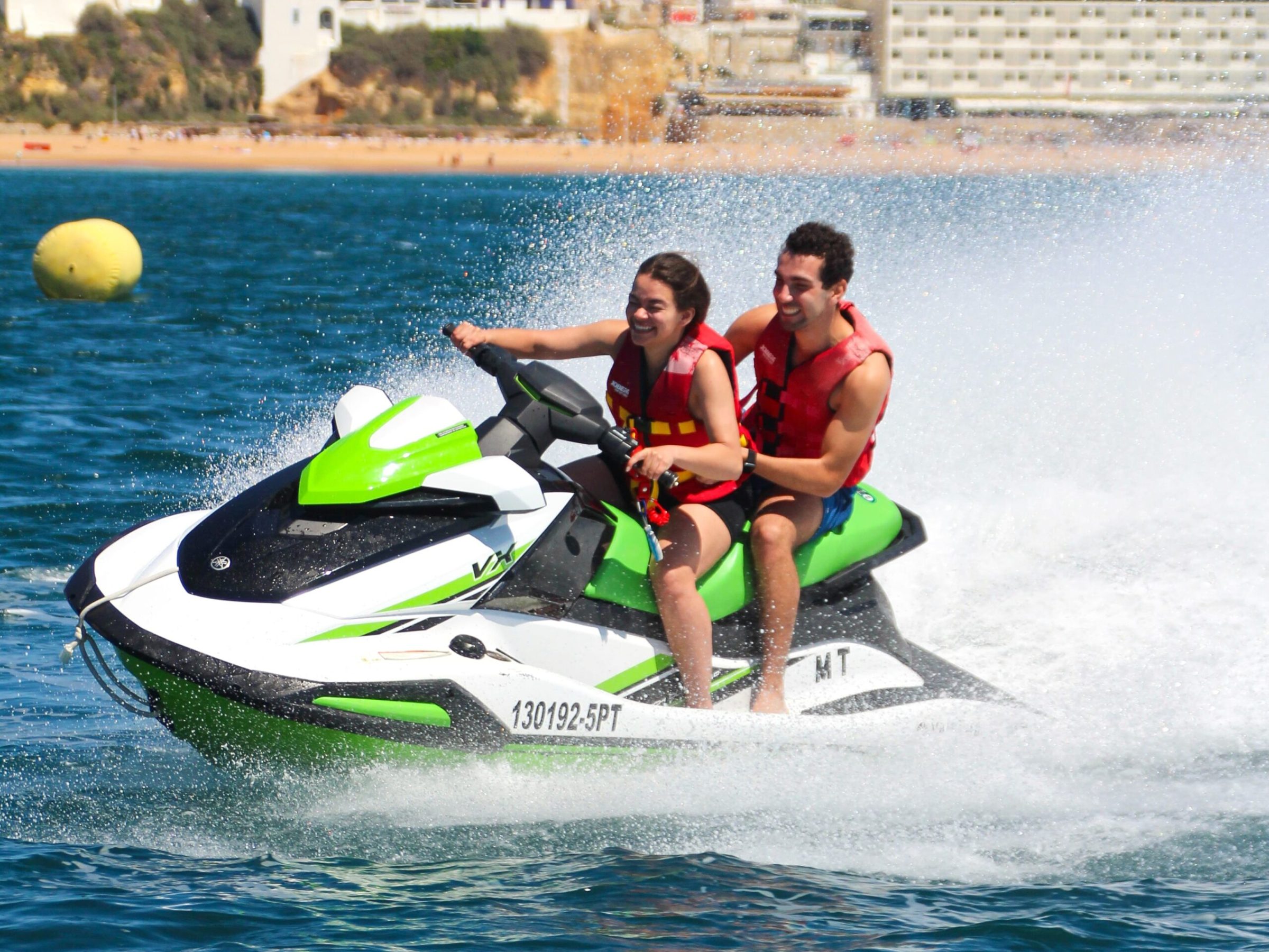 a young girl riding a wave on a surfboard in the water